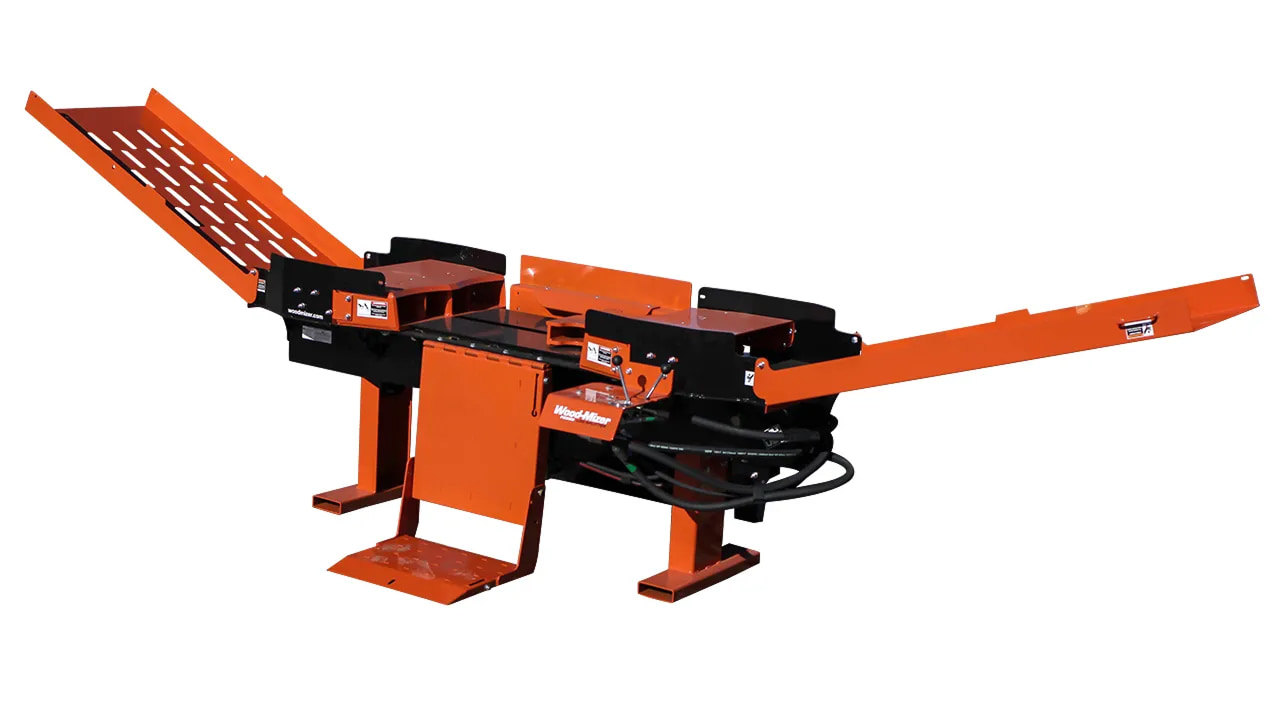 Orange industrial log conveyor/feeding machine with inclined ramps and hydraulic components for wood processing.